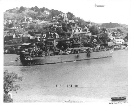 LST-311 in front of town, Barrage Balloon overhead