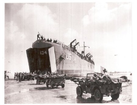Jeeps carrying casualties to waitin LST-134, 1944